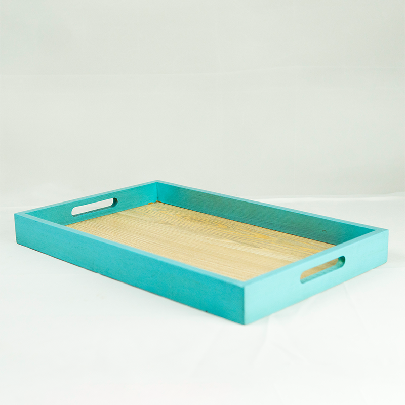 Turquoise tray with wooden surface on a white background