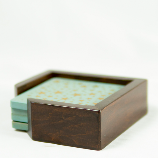 Wooden coaster set with green coasters on a white background