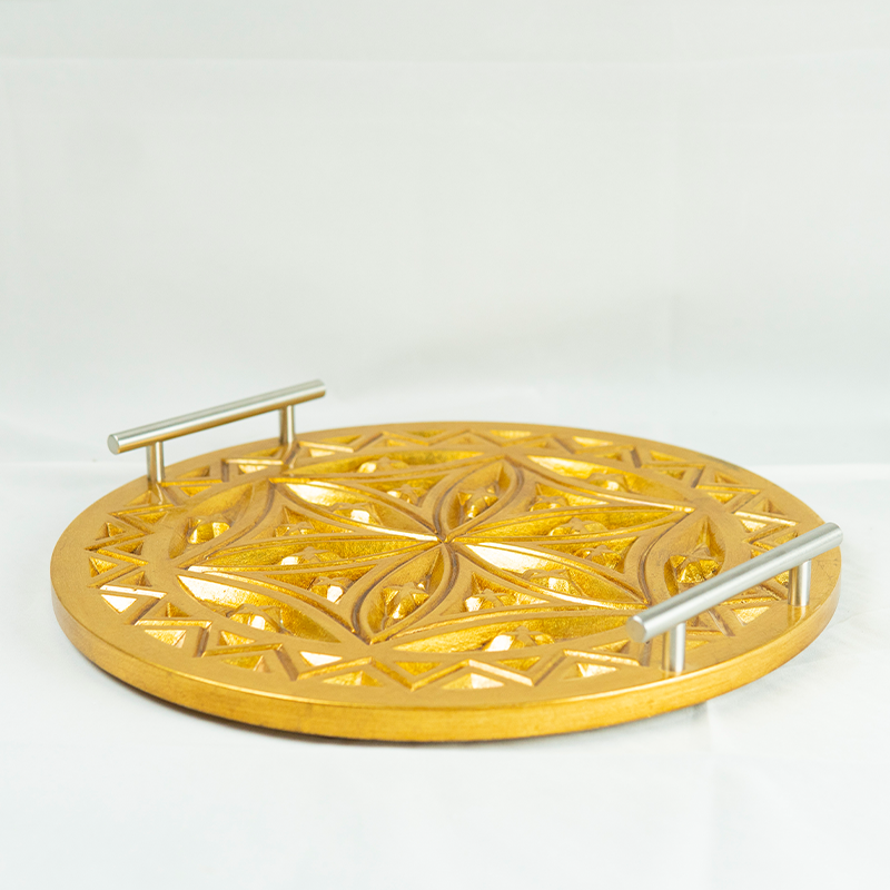 Gold decorative tray with intricate patterns on a white background