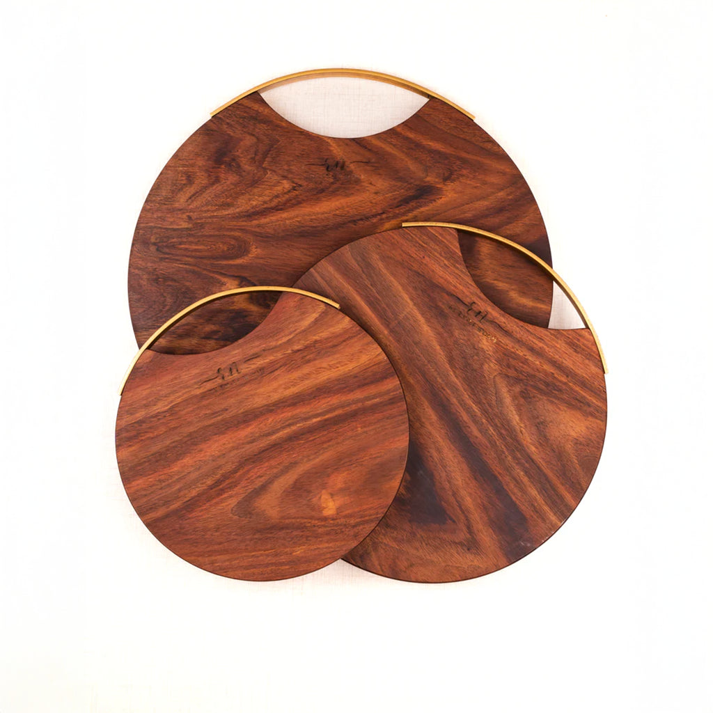 Set of three wooden coasters with gold rims on a white background