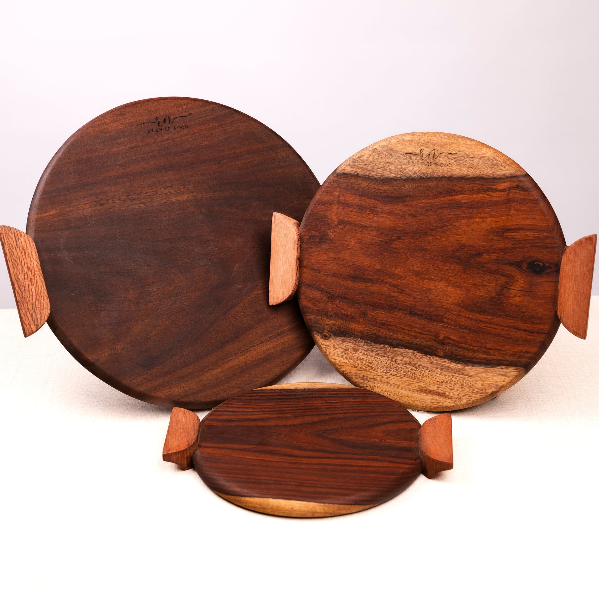 Set of three wooden Pizza boards with handles on a white background