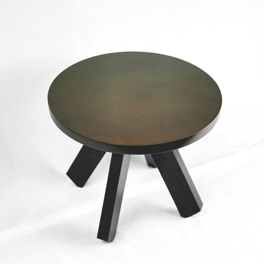 Round wooden table with four legs on a white background
