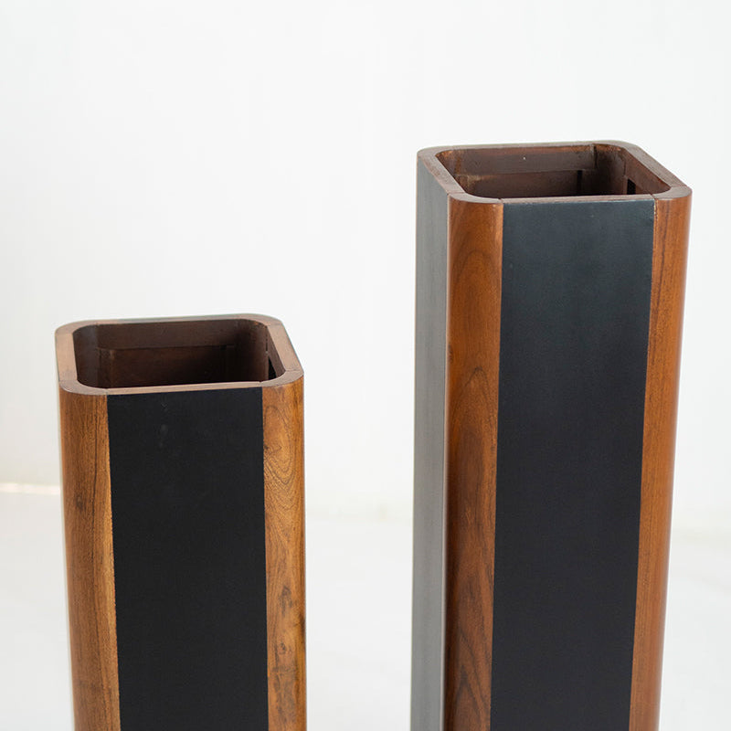 Two tall, rectangular planters with wooden sides and black fronts on a white background